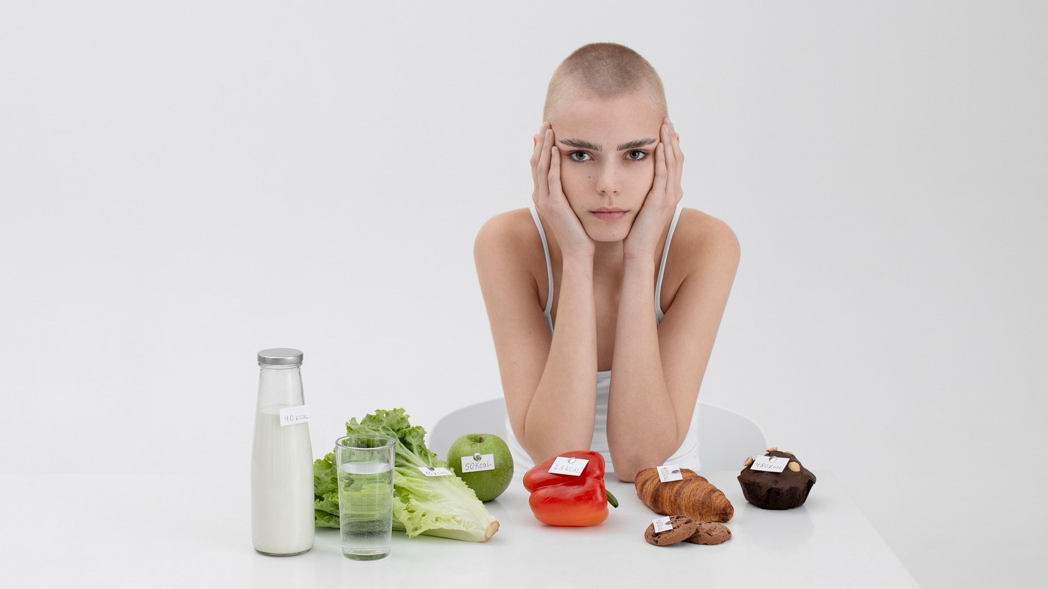 8 Misleading “Healthy” Habits That May Be Sabotaging Your Body young-woman-with-eating-disorder-food-with-calories-numbers